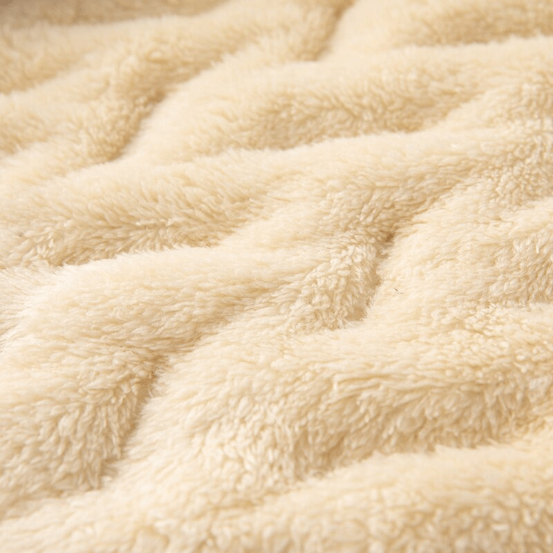 Close-up of soft, plush lambswool fabric in a warm, creamy hue, showcasing texture ideal for cozy apparel like vests or jackets.